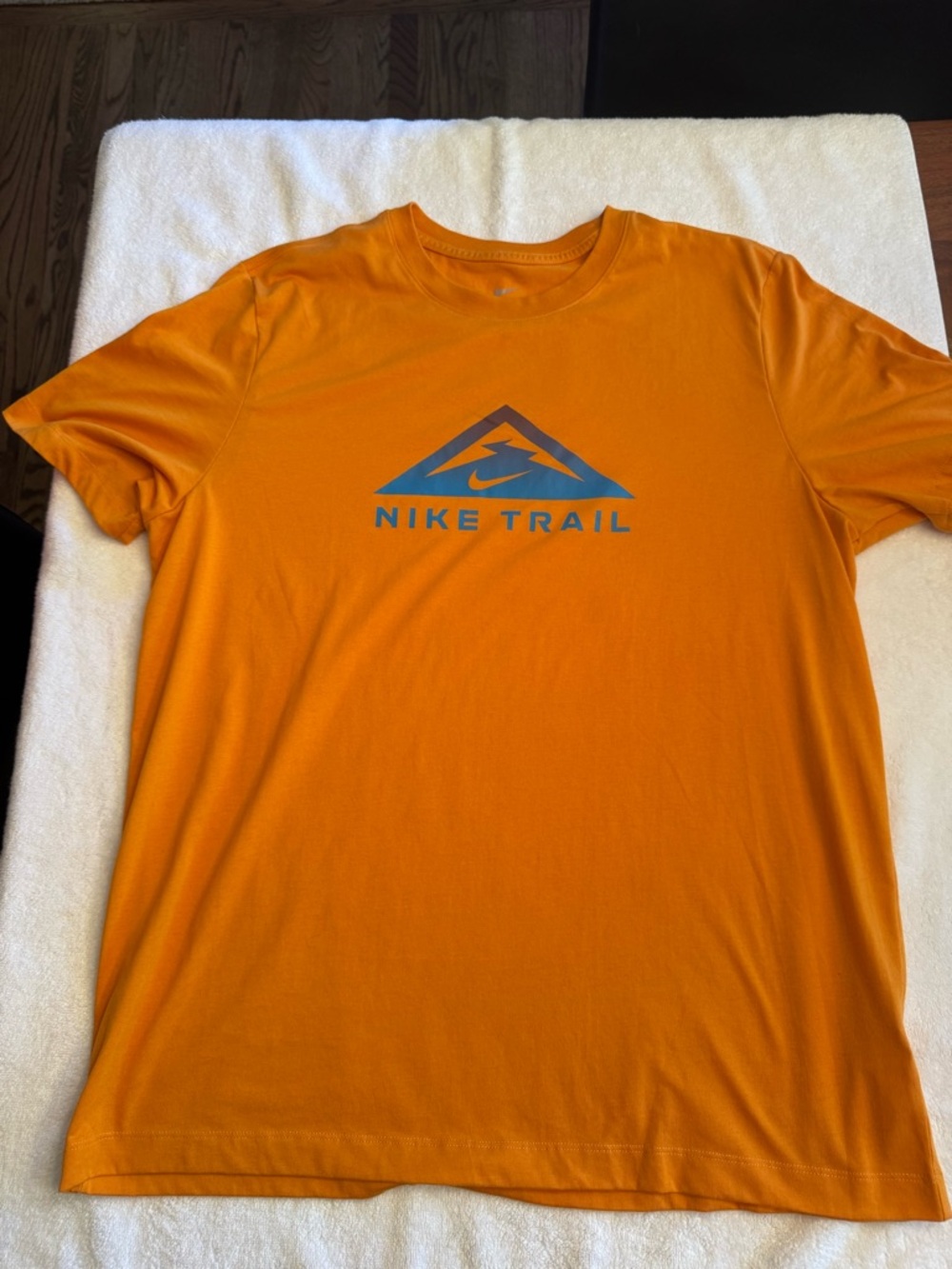 Nike Orange Short Sleeve Tee with Blue Nike Trail Logo. Great condition.